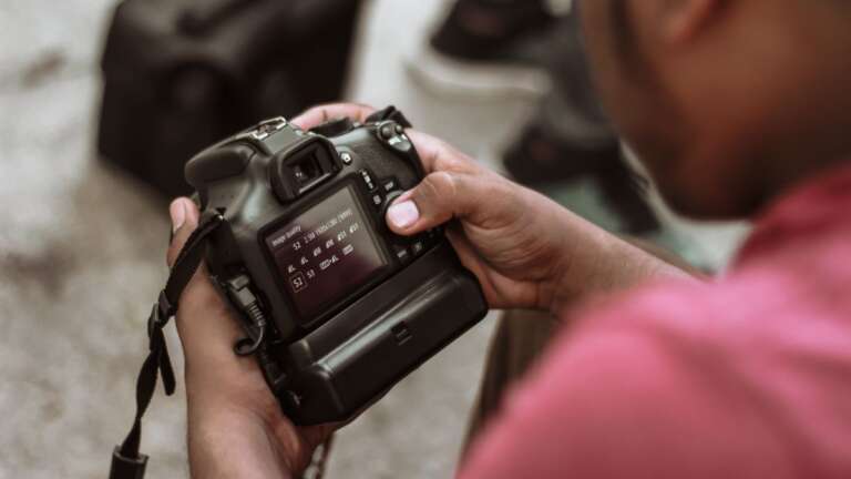 Man adjusting settings on a digital camera