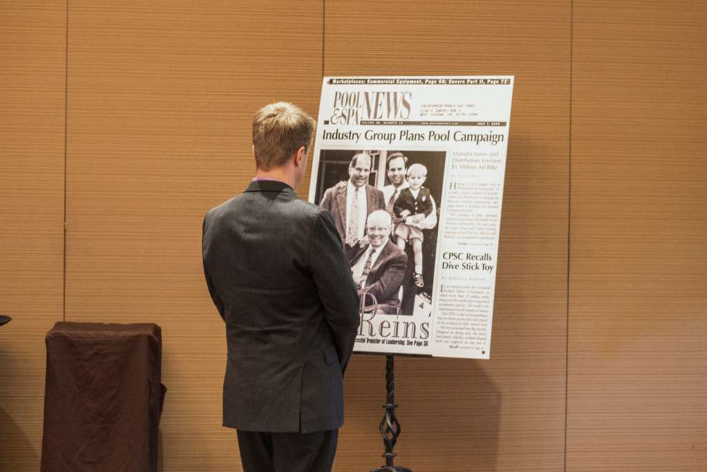 Grandson of California Pools founder, Ryder Steimle, previews a large format photo printing newspaper article