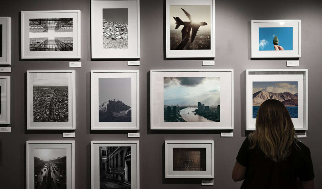 a collection of Print work in frames on wall artisanhd