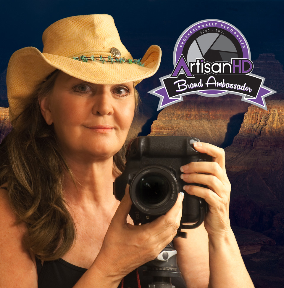 Suzanne Mathia self photo with Brand ambassador badge holding camera and wearing a cowgirl hat