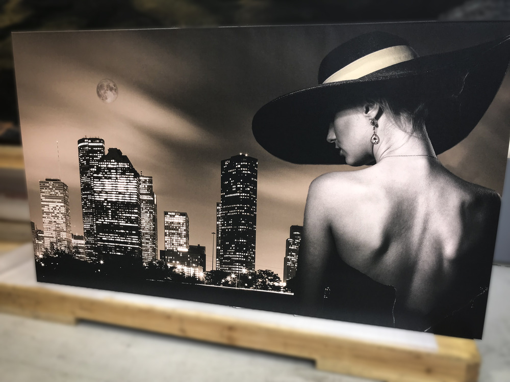printed photo of a city and a girl