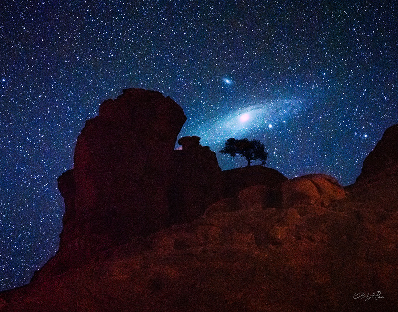 Photography of Andromeda Galaxy rising above Bell Rock in Sedona